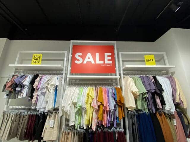 Clothing merchandised in a sale section.