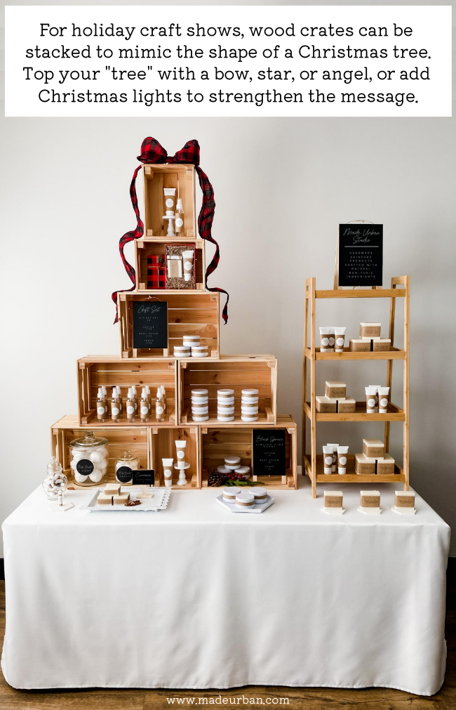 Wood crates stacked in the shape of a Christmas tree on a craft show table